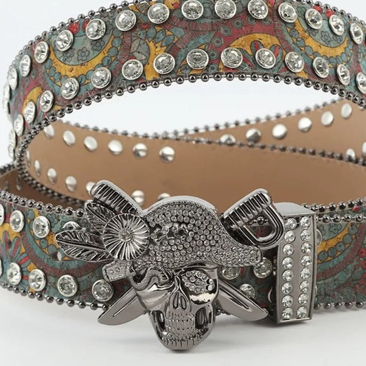 Decorative belt with skull buckle and paisley pattern on a white background