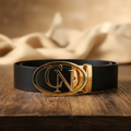 Black leather belt with oval initial buckle in gold tone