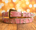 Pink rhinestone belt with gold buckle, white stripe, and pointed keeper end