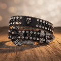 Black skull-buckle belt with crystal-studded panels and side spikes, front view